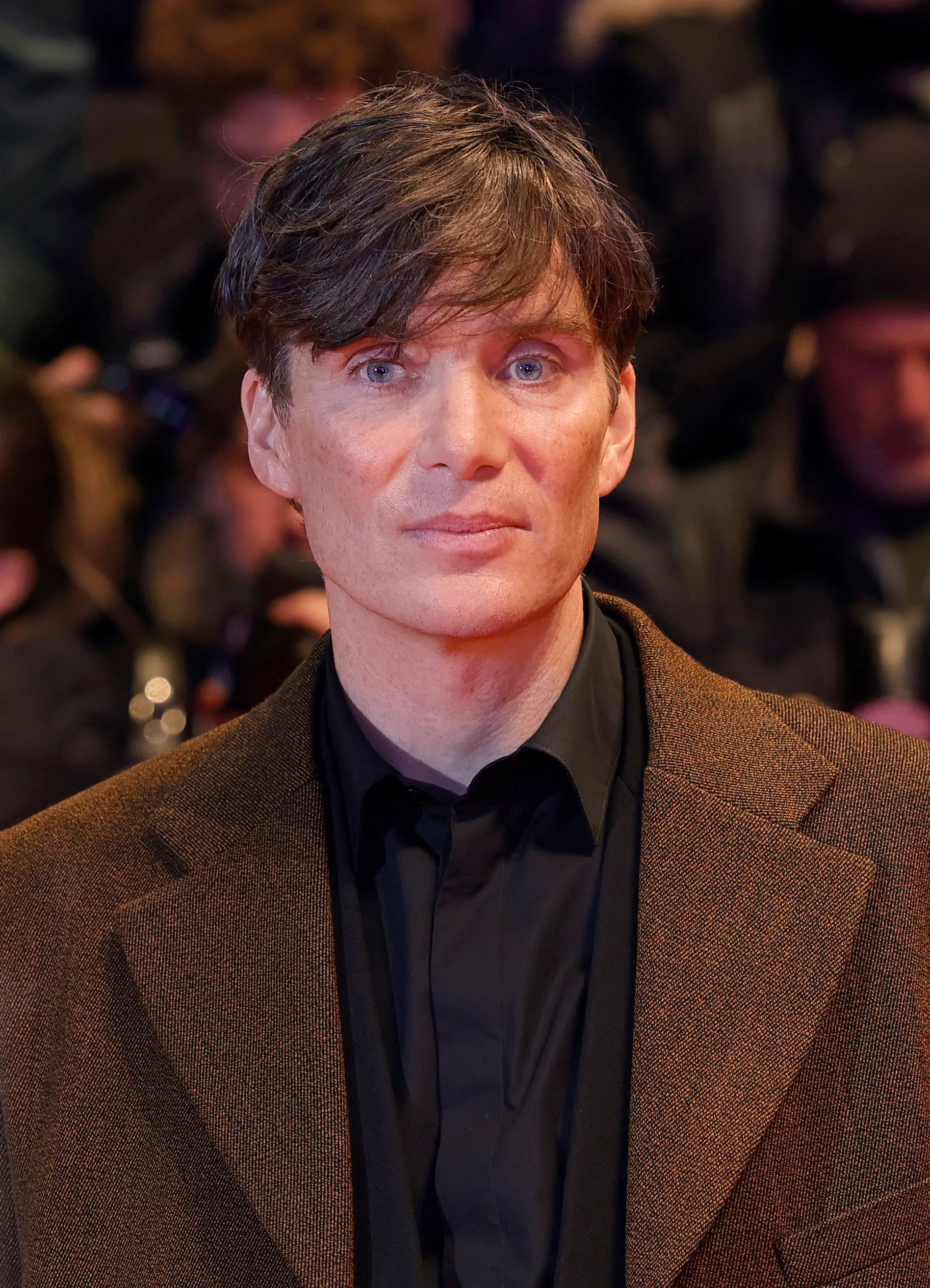 Cillian Murphy at the Berlinale 2024 red carpet with short, textured hair and a loose side-swept fringe.