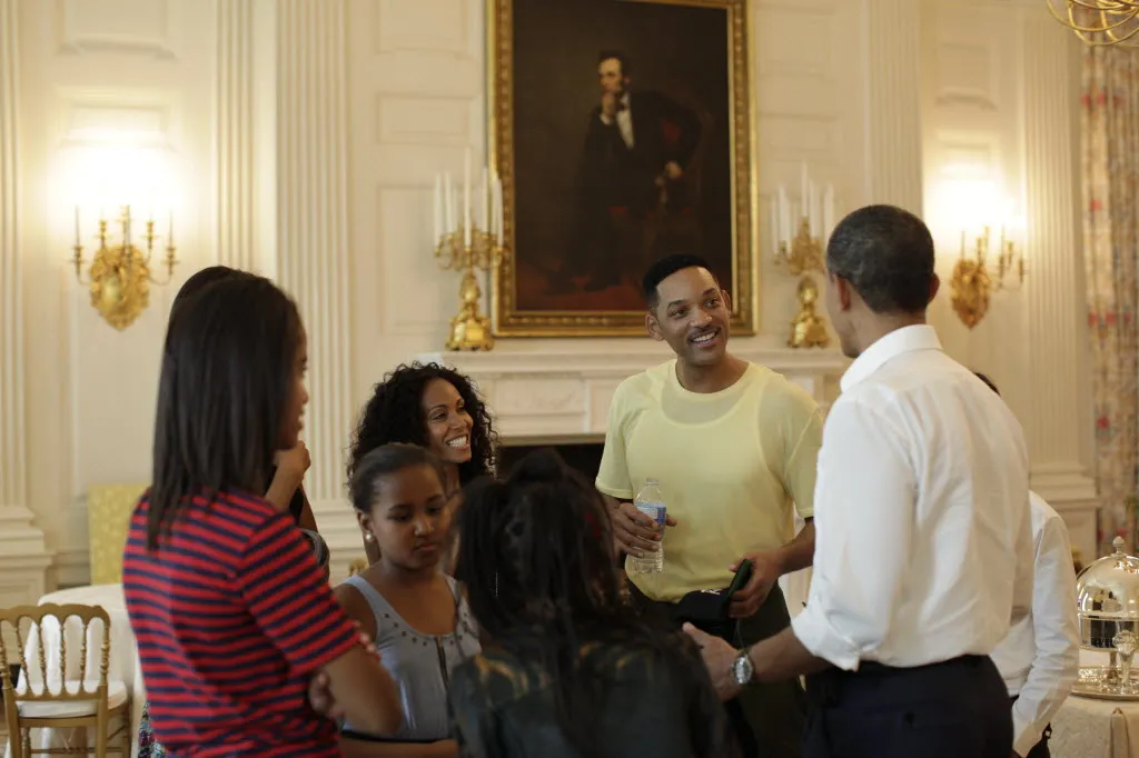 Will Smith standing at a 2011 White House event with a low squared flat-top haircut.